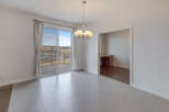 This bright and airy dining area features a stunning view through large sliding glass doors.