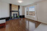 This stunning living room boasts a beautiful stone fireplace, creating a warm and inviting atmosphere.