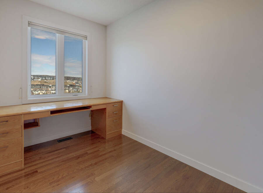 This bright and airy room features a large window that floods the space with natural light.