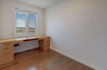 This bright and airy room features a large window that floods the space with natural light.