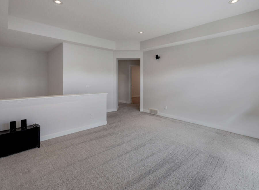 Step into this bright and airy living space, featuring a neutral color palette and plush carpeting.
