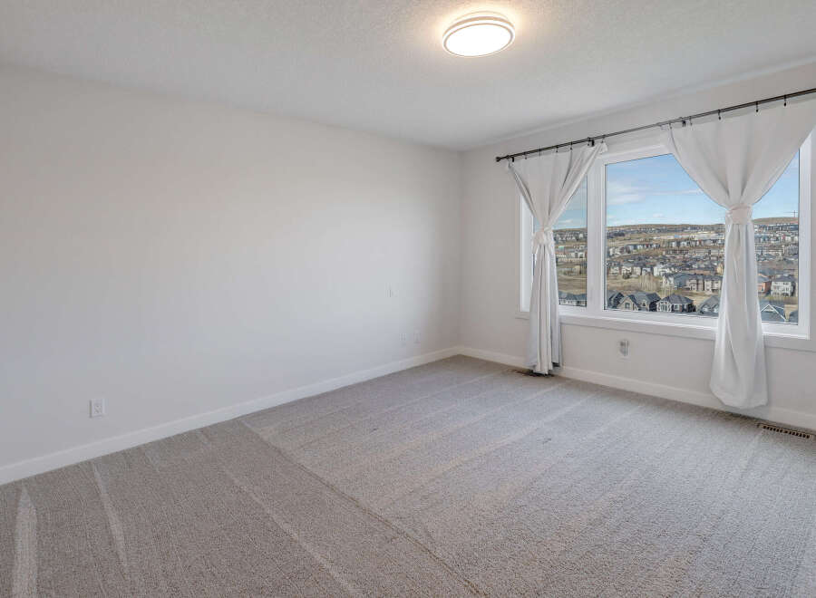 Step into this bright and airy bedroom, featuring neutral tones and ample natural light.