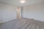 Step into this bright and airy room, featuring pristine white walls and plush, neutral-toned carpeting.