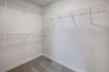 This spacious walk-in closet offers ample storage with its wire shelving system.