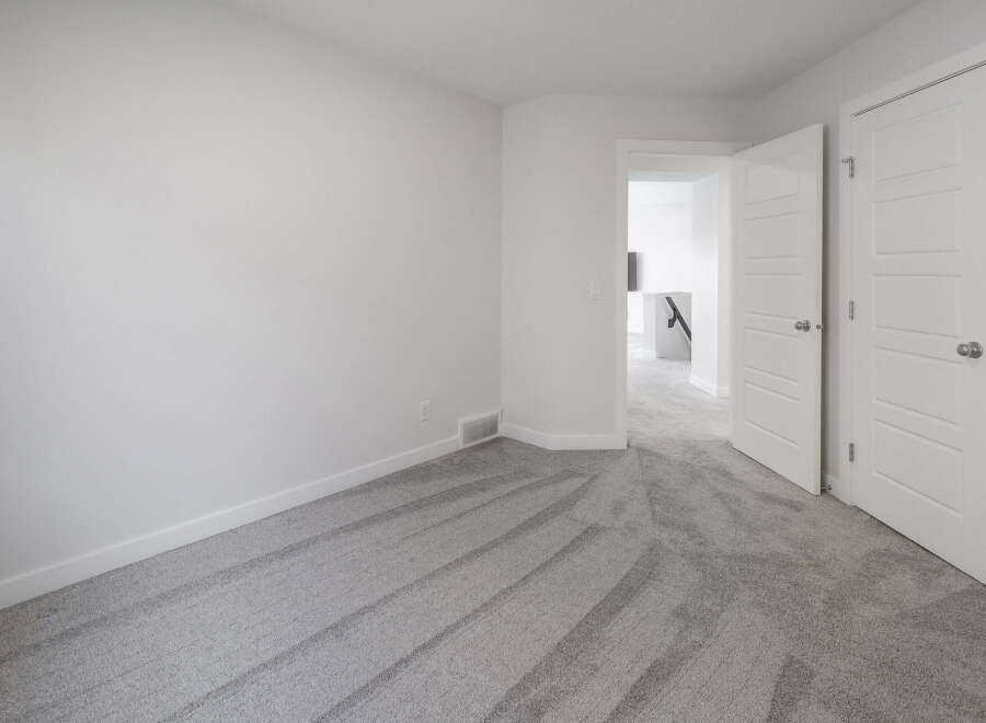 Step into this bright and airy room, featuring pristine white walls and a neutral-toned carpet that creates a sense of calm.