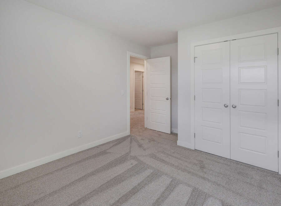 Step into this bright and airy bedroom, featuring a neutral color palette and ample natural light.