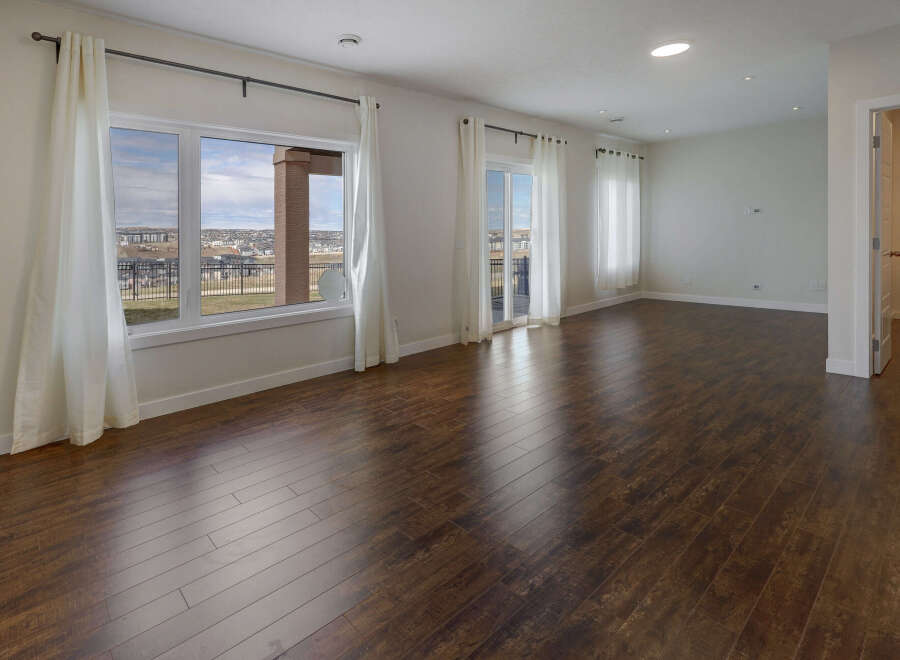 Step into this stunning living space, bathed in natural light and boasting elegant hardwood floors.