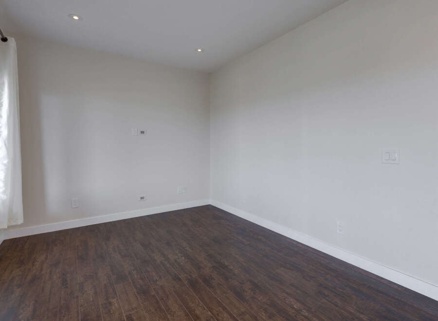Discover the elegance of this stunning property, featuring a spacious interior with pristine white walls.