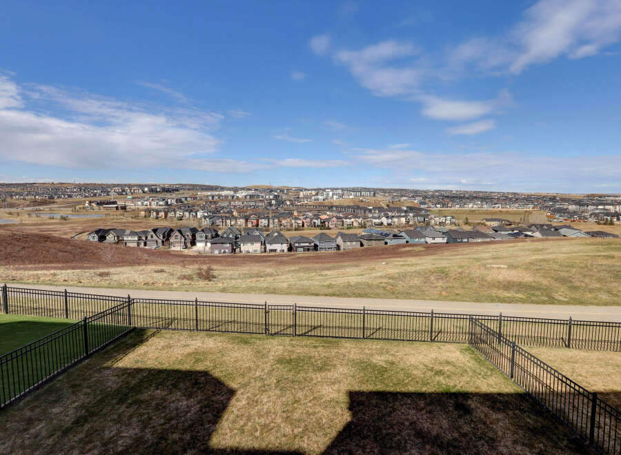 Enjoy stunning views from this beautiful property! This home features a spacious backyard with a charming black fence, perfect for outdoor gatherings.