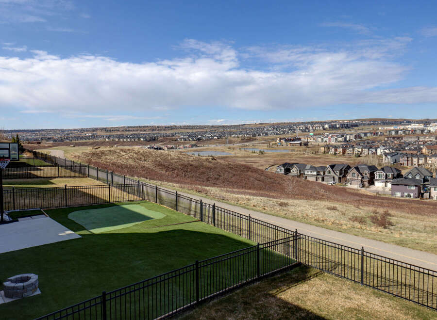 Enjoy breathtaking views from this stunning property! This home features a beautifully landscaped backyard with a putting green and a basketball court, perfect for outdoor activities.
