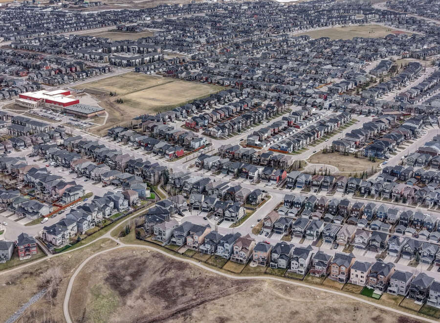 Explore this stunning aerial view of a modern residential neighborhood, showcasing a variety of stylish homes with dark gray roofs.