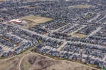 Explore this stunning aerial view of a modern residential neighborhood, showcasing a variety of stylish homes with dark gray roofs.