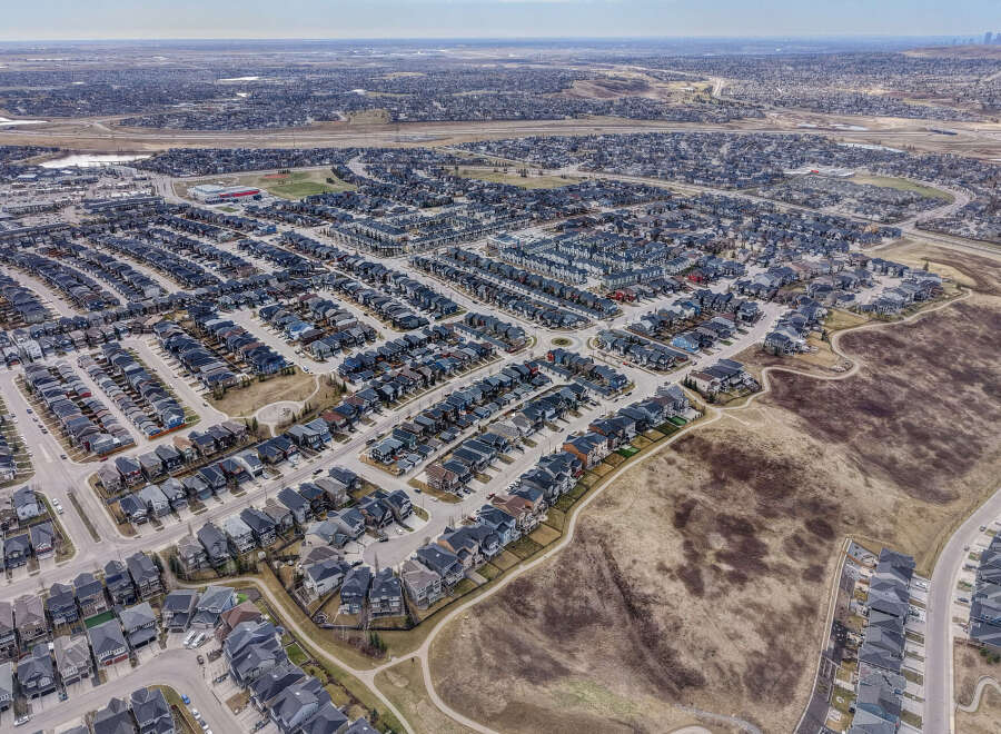 Discover the charm of this stunning residential neighborhood, featuring a variety of modern homes with dark gray roofs and well-maintained landscaping.