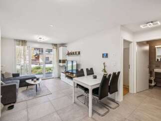 Discover modern living in this stylish apartment! Featuring a bright and open floor plan, this property boasts a sleek dining area and a comfortable living space.