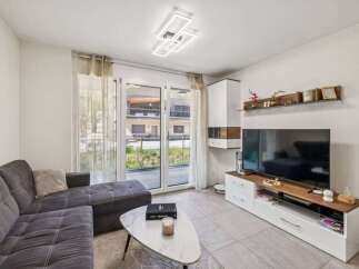 Discover modern living in this stylish property! Featuring a spacious living room with a comfortable sofa and a sleek coffee table, perfect for relaxation.