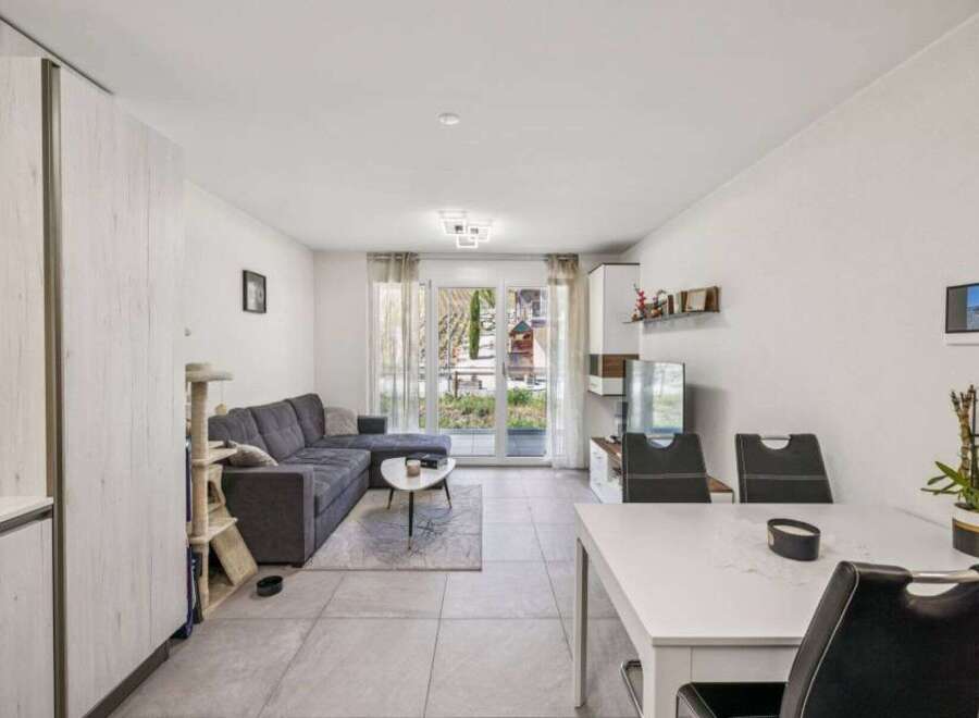 Discover modern living in this stylish property, featuring a spacious living area with a comfortable sectional sofa.