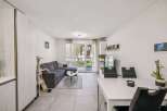 Discover modern living in this stylish property, featuring a spacious living area with a comfortable sectional sofa.