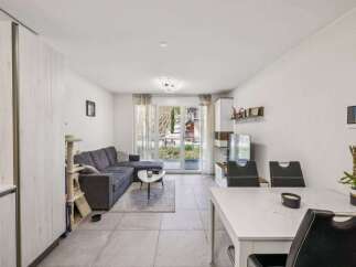 Discover modern living in this stylish property, featuring a spacious living area with a comfortable sectional sofa.