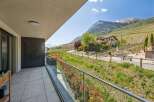 Enjoy breathtaking views from this stunning property! This home features a spacious balcony with glass railings, perfect for taking in the surrounding landscape.