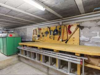 This property features a well-organized workshop space, perfect for DIY enthusiasts or those needing a dedicated area for projects.