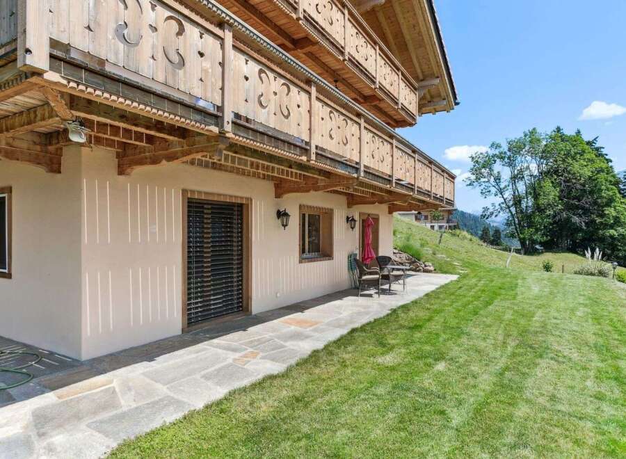 Discover the charm of this stunning property, boasting a beautifully designed exterior with intricate wooden details and a welcoming facade.