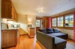 Discover the charm of this cozy property, featuring a well-equipped kitchen with wooden cabinetry and a stylish countertop.