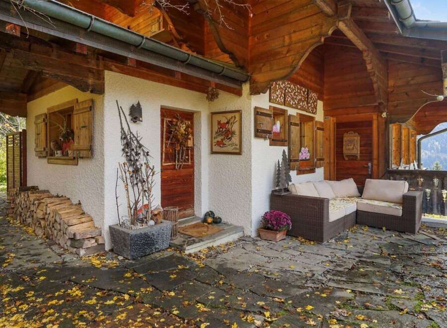 Discover the charm of this stunning property, featuring a cozy outdoor seating area perfect for relaxation.