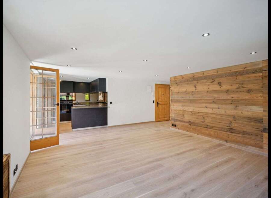Discover the charm of this stunning property, featuring a modern kitchen and a warm, inviting wooden accent wall.