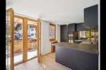 This stunning kitchen boasts a modern design with sleek cabinetry and a spacious countertop, perfect for culinary enthusiasts.