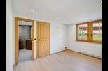Discover the charm of this inviting room, featuring warm wooden doors and a bright, airy ambiance.