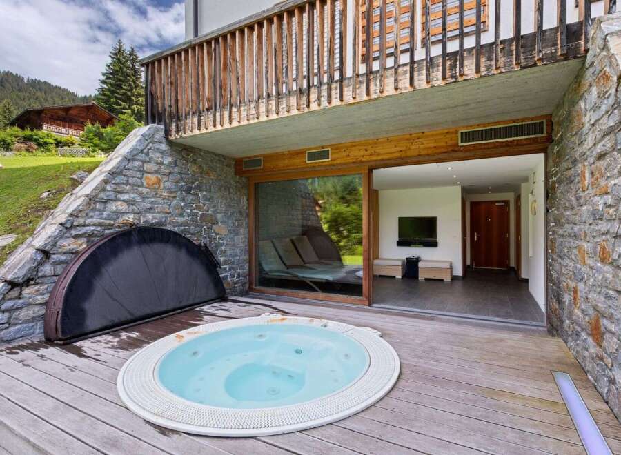 Experience luxury living with this stunning property featuring a private hot tub and a spacious outdoor deck.
