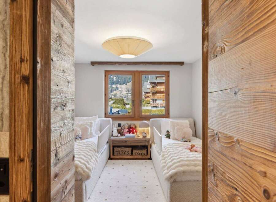 Step into a cozy and inviting bedroom with a stunning mountain view.