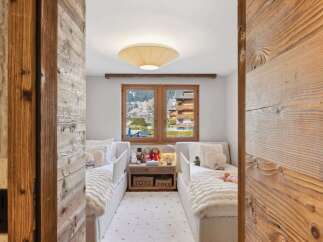 Step into a cozy and inviting bedroom with a stunning mountain view.