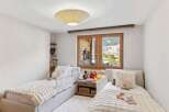 This charming bedroom features two cozy beds, perfect for a child's retreat.