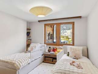 This charming bedroom features two cozy beds, perfect for a child's retreat.