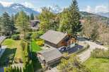 Nestled in a picturesque mountain setting, this charming wooden house offers a serene escape.