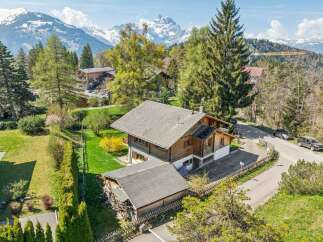 Nestled in a picturesque mountain setting, this charming wooden house offers a serene escape.