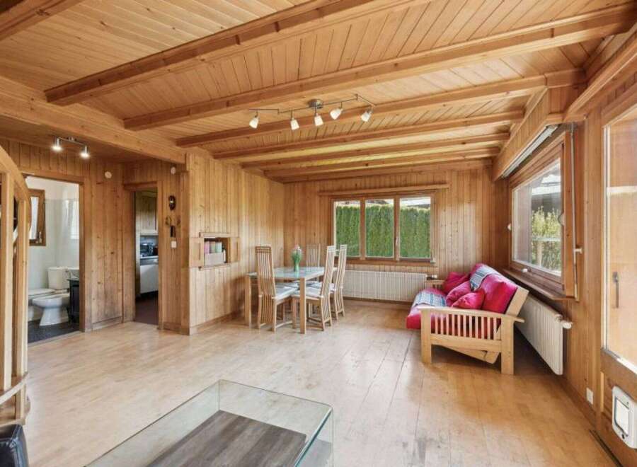 Step into this inviting home with its warm wooden interior, creating a cozy and comfortable atmosphere.