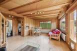 Step into this inviting home with its warm wooden interior, creating a cozy and comfortable atmosphere.