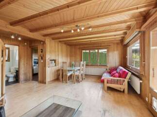 Step into this inviting home with its warm wooden interior, creating a cozy and comfortable atmosphere.