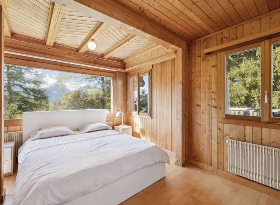 Experience the tranquility of this stunning bedroom with breathtaking mountain views.