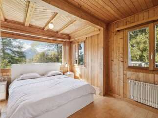 Experience the tranquility of this stunning bedroom with breathtaking mountain views.