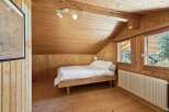 This cozy bedroom features beautiful wooden paneling throughout, creating a warm and inviting atmosphere.