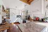This bright and airy kitchen features modern white cabinetry, offering ample storage and a clean aesthetic.