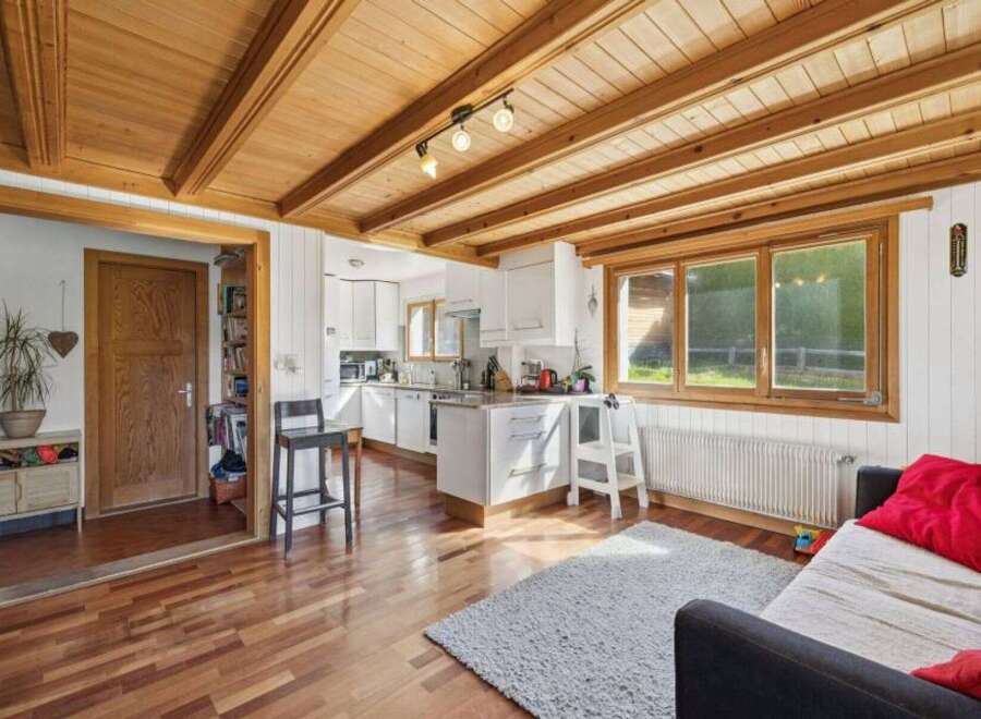 This charming property boasts a warm and inviting interior, featuring beautiful wooden ceilings and flooring throughout.