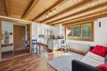 This charming property boasts a warm and inviting interior, featuring beautiful wooden ceilings and flooring throughout.