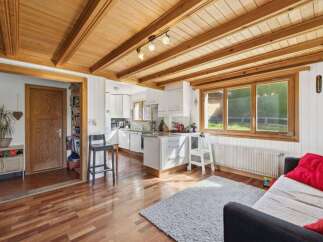 This charming property boasts a warm and inviting interior, featuring beautiful wooden ceilings and flooring throughout.