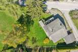 Discover this stunning property featuring a charming house with a well-maintained roof and a spacious green yard.