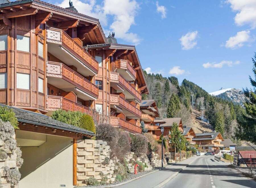 Discover the charm of this stunning property, featuring exquisite wooden architecture and balconies.