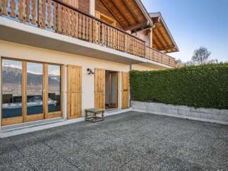 Discover the charm of this stunning property, boasting a beautiful wooden balcony and inviting outdoor space.